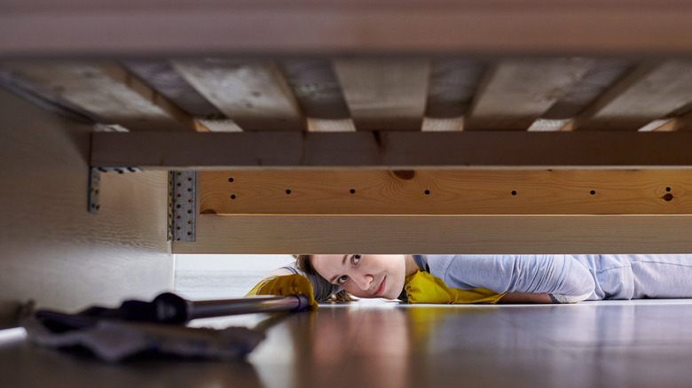 Woman grabbing lint with tongs