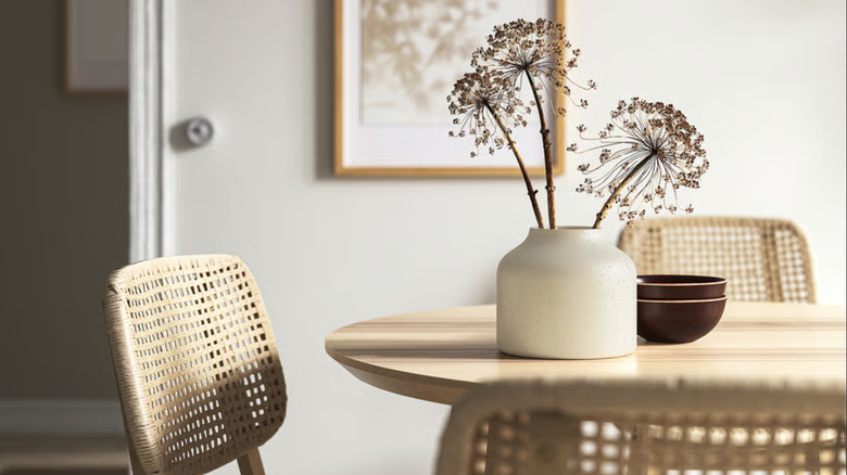 BLODBJÖRK vase on top of a dining room table with flowers inside