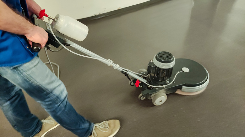 person polishing flooring with a floor buffer