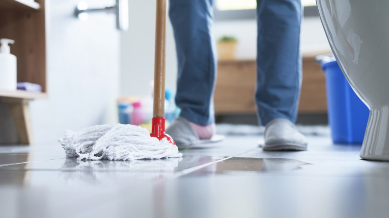 person using mop on wet floor