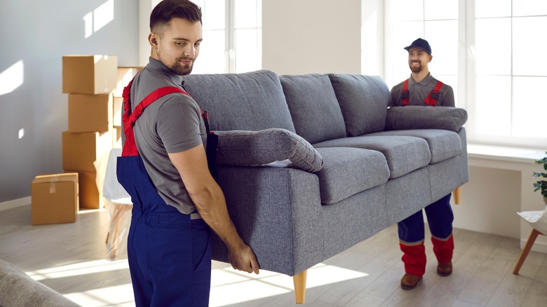 Professional movers lifting couch