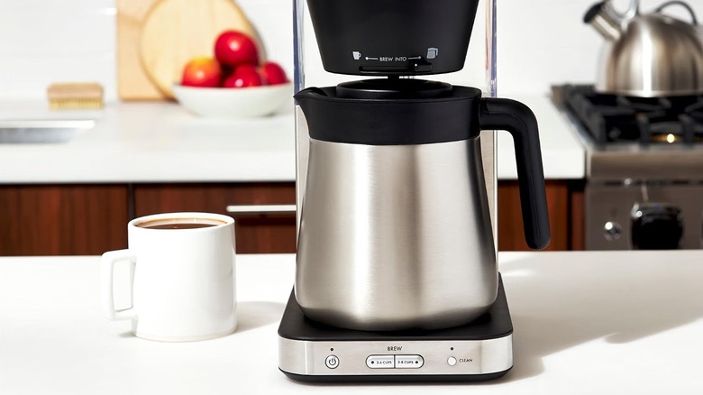 OXO coffee maker brewing a cup of coffee on a kitchen island