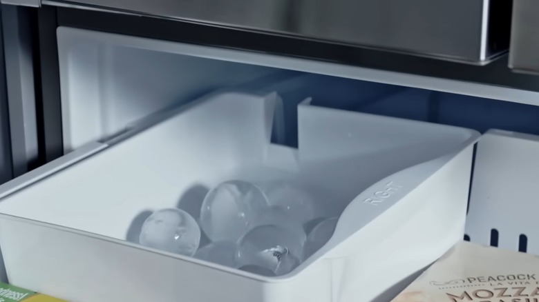 Round ice inside a white craft Ice maker tray in a LG fridge