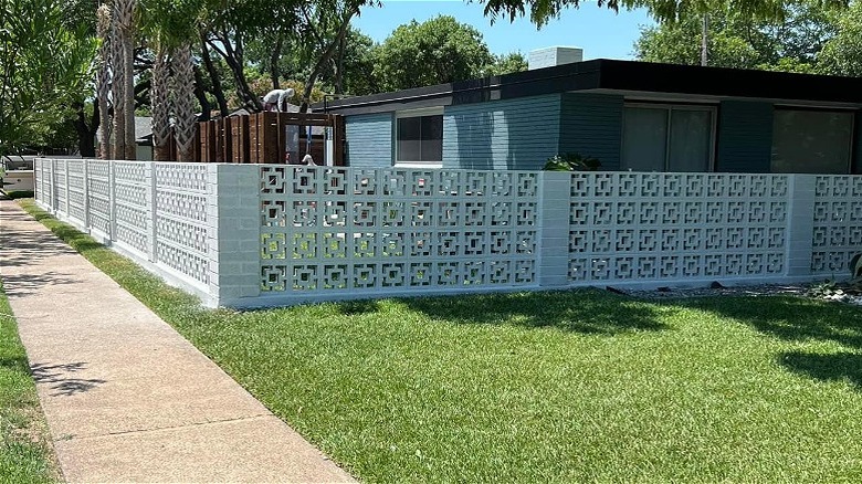 Midcentury ranch house surrounded by decorative concrete breezeblock garden walls