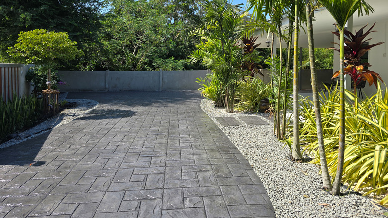 Stamped concrete driveway outside of a midcentury modern home.