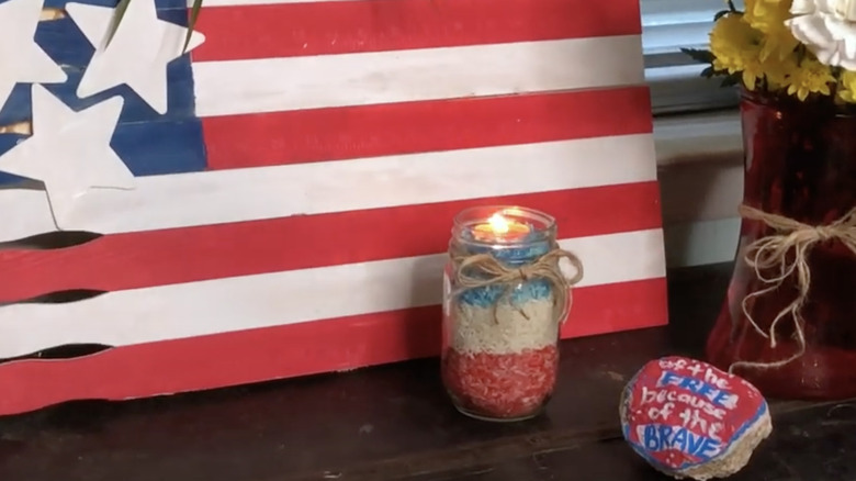 A festive jar with a votive candle lit