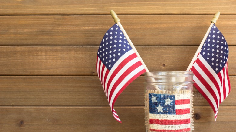 A glass jar with American flags sitting in it