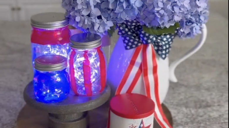 A trio of painted mason jars with LED lights inside