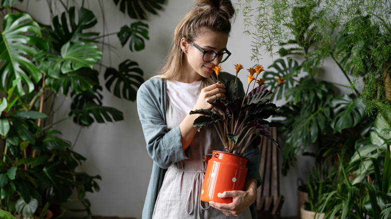 woman smelling plants