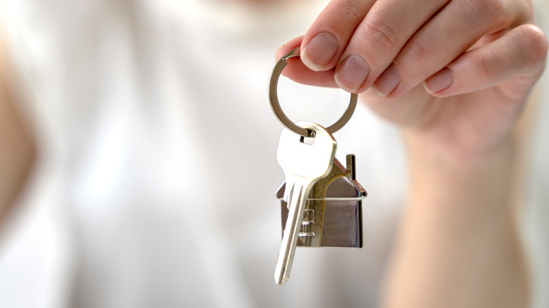 person holding keys to home