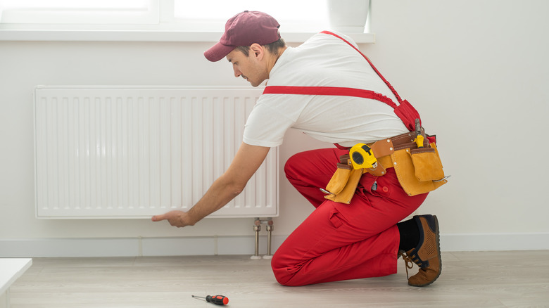 handyman installing radiator