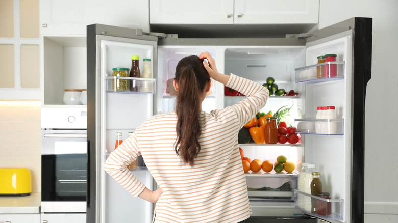 lady checking inside a refrigerator