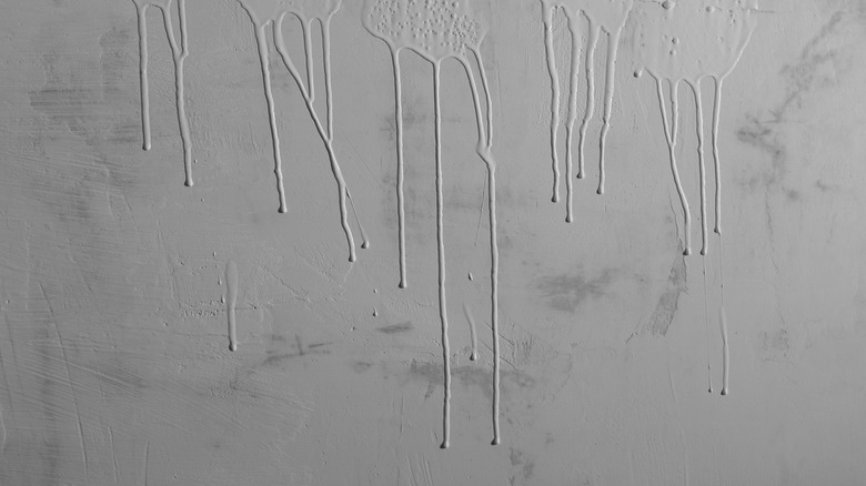Gray paint dripping down wall