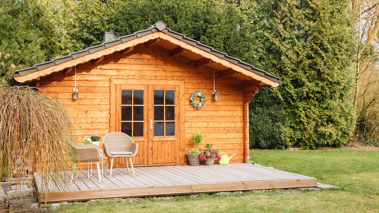 porched wooden shed in backyard