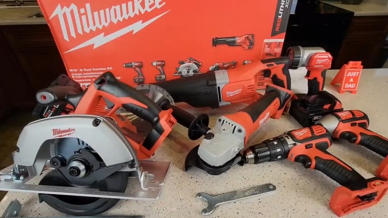 Six-tool Milwaukee kit unpacked on table in front of packaging