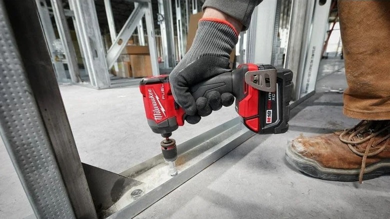 Person using a 1/4-inch Milwaukee impact driver