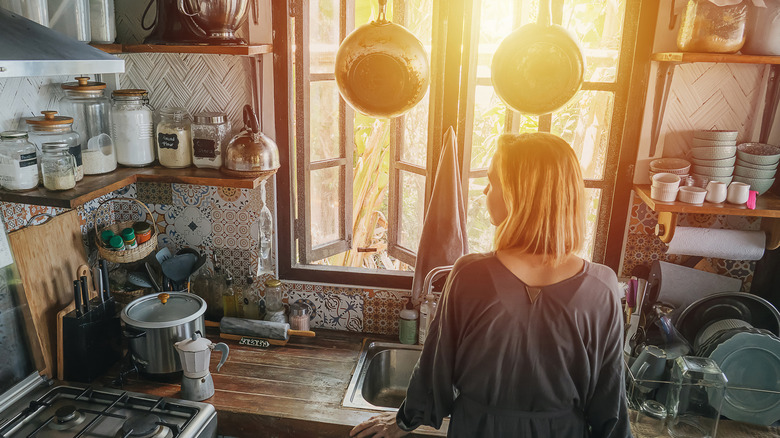 woman in cluttered kitchen