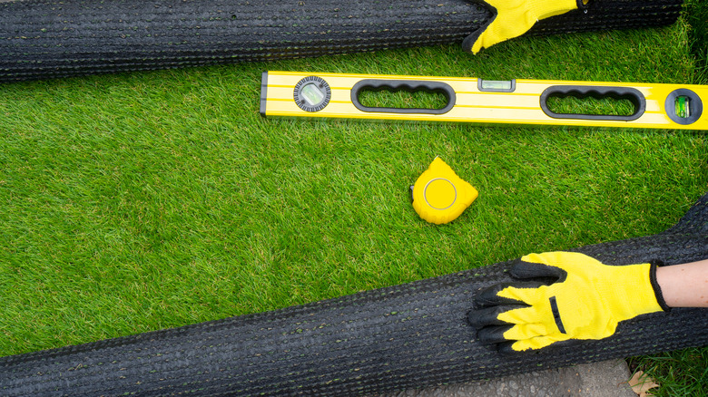 Person installing artificial grass