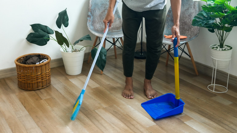 Person sweeping the floor