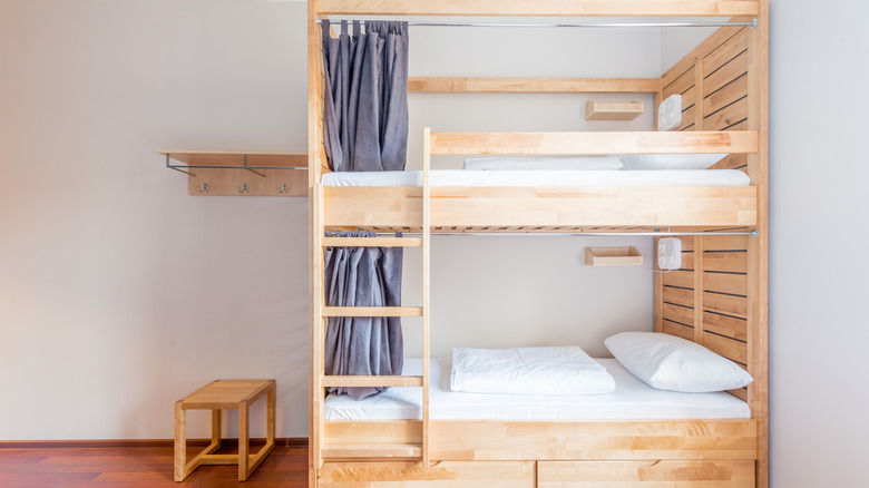 Wooden bunk bed with curtains