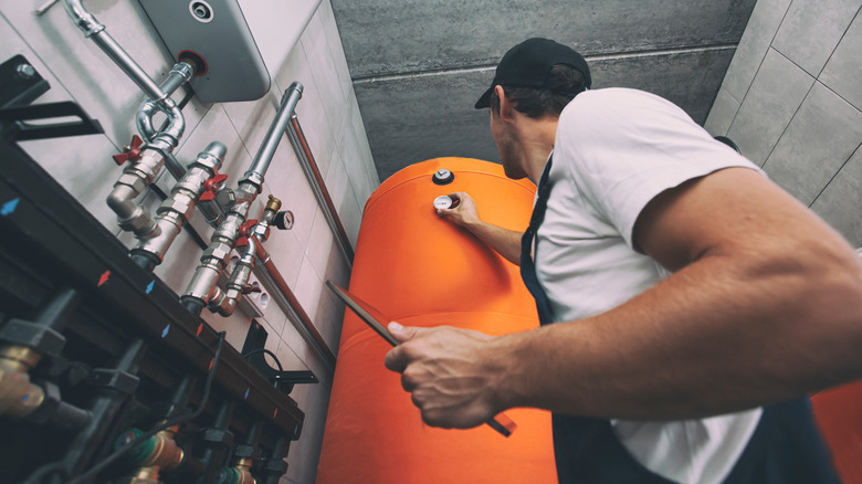 Man checking gauge on plumbing