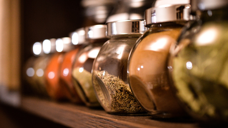 spice jars on wooden shelf