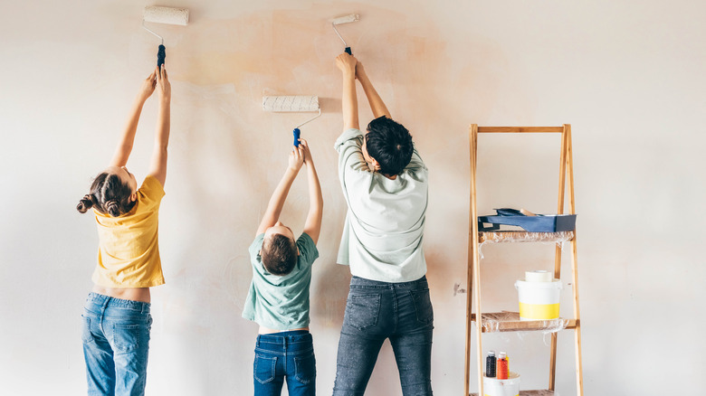 Family painting a wall