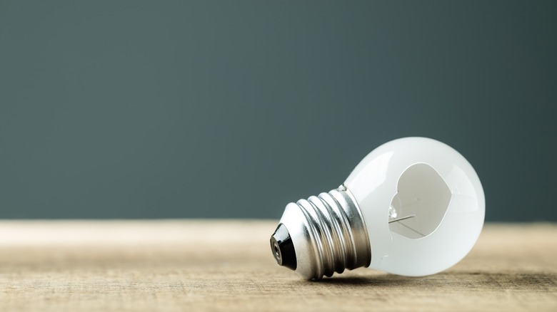 Woman changing light bulb