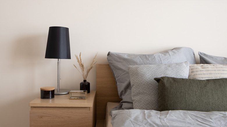 wooden nightstand with black lamp