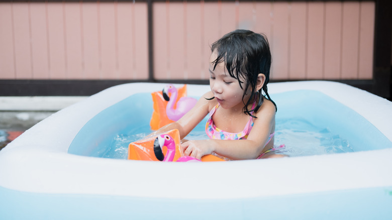 child playing in pool