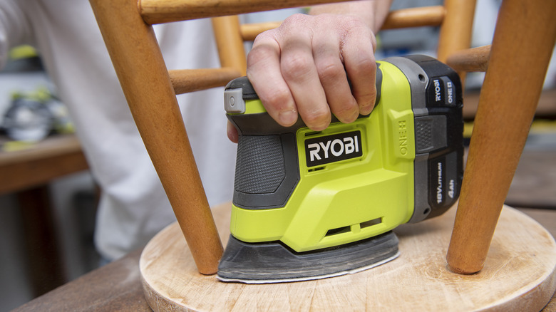 Power sanding wooden stool