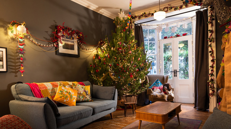 large Christmas tree in corner of room with decorations