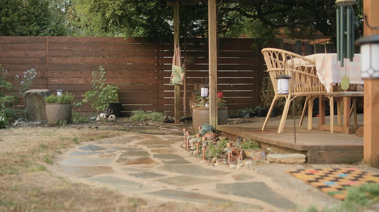 A paver extended patio that doubles as walkway in garden backyard.