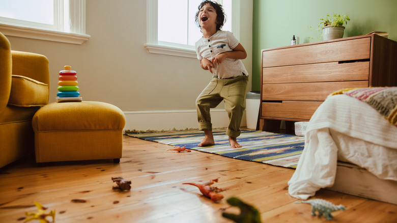 boy playing in green room 