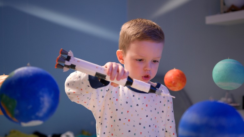 boy playing with toy rocket