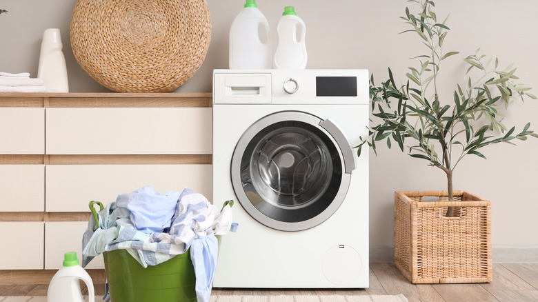 A basic washing machine in a laundry room