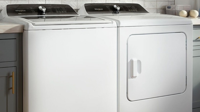 Whirlpool white washer and dryer in a laundry room