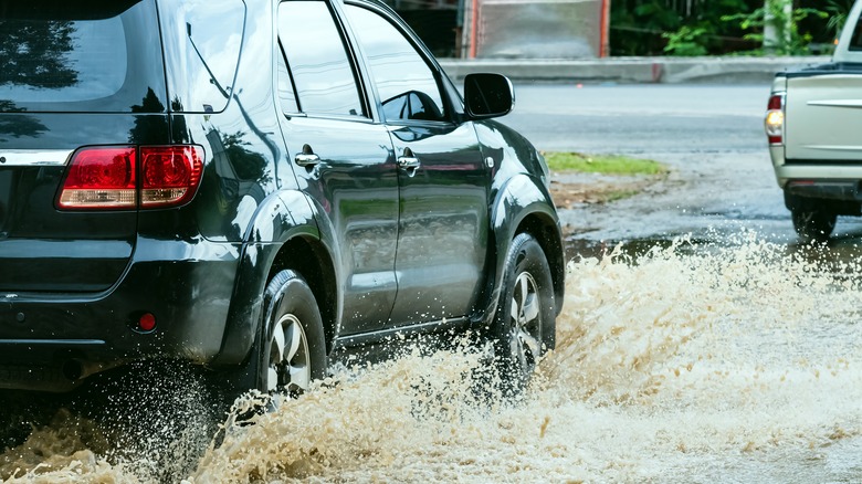 car driving through floodwater