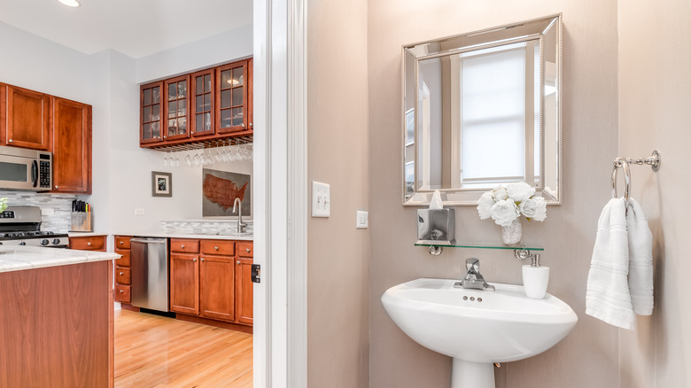 half bathroom opening to kitchen