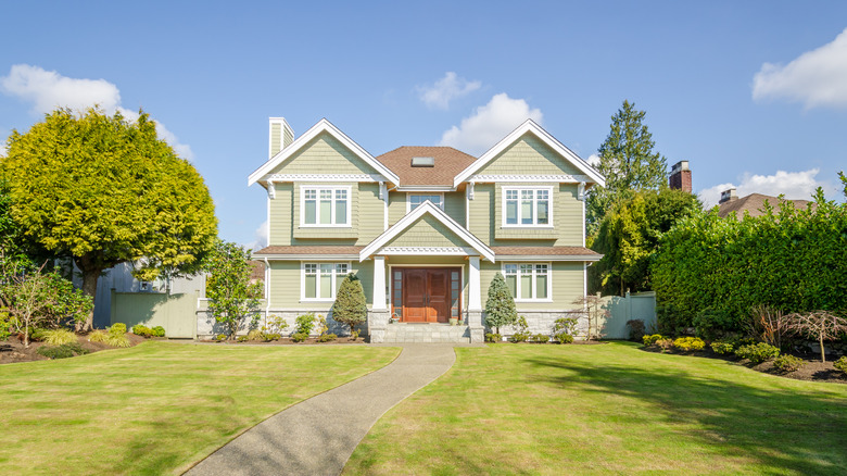 large green house with yard