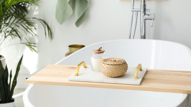 Bamboo tray on white bath tub
