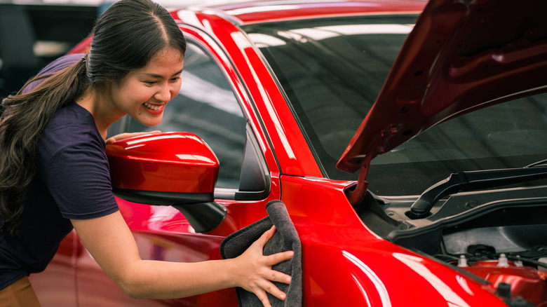 Woman polishing a car