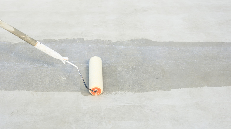 A white roller being used to repair concrete