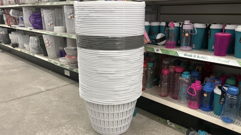 Stack of white and gray Dollar Tree laundry baskets in store's kitchen section