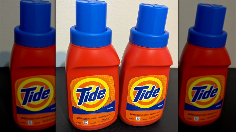 Miniature Tide laundry bottles on black tabletop