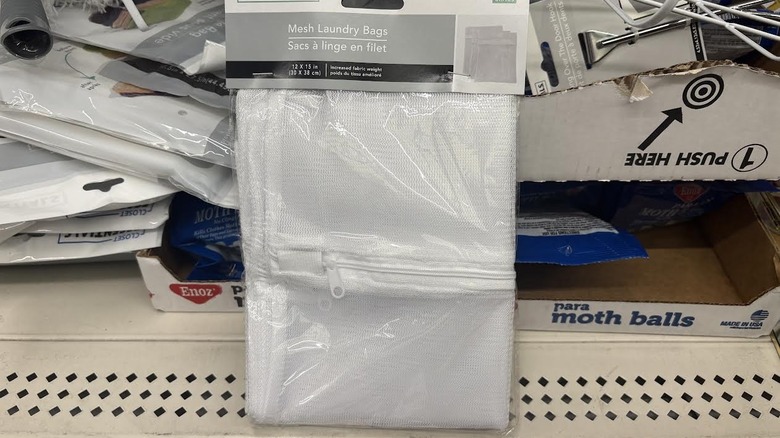 Packaged mesh laundry bag on messy Dollar Tree shelf