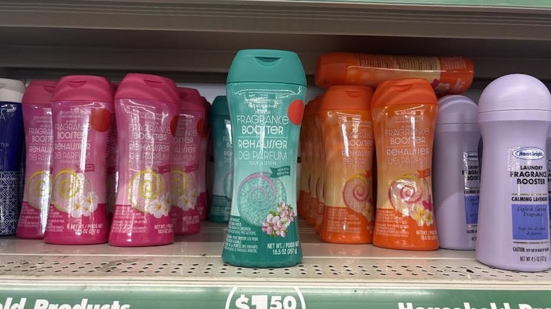 Assortment of Dollar Tree laundry fragrance boosters in different scents with teal in front