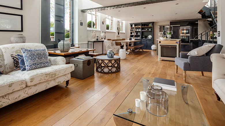 An open plan kitchen, living room, and dining room with continuous wood flooring