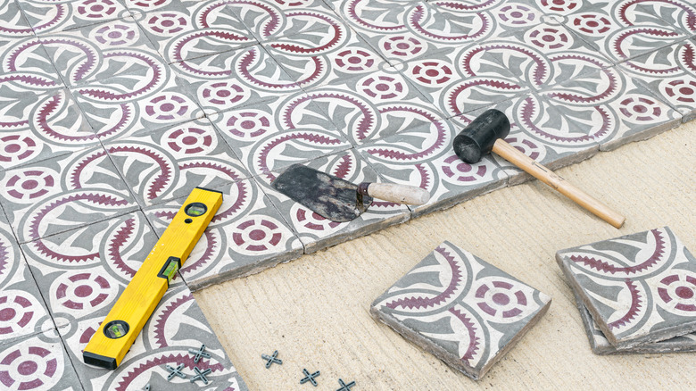 A shot of a partly-laid encaustic-tile floor