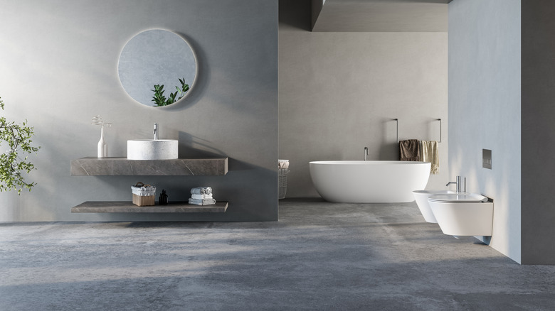 A modern bathroom scene with gray flooring